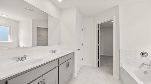 1141 Kingston Ave, Buckhead, GA 30625 - bathroom featuring double vanity, a bath, marble look tiles, a spacious closet, and baseboards