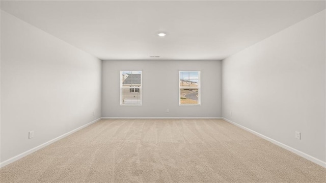 unfurnished room featuring light colored carpet