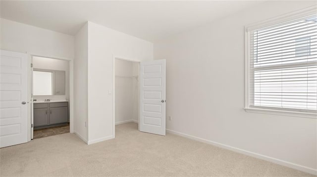 1141 Kingston Ave, Buckhead, GA 30625 - unfurnished bedroom featuring light colored carpet, baseboards, a closet, a spacious closet, and a sink