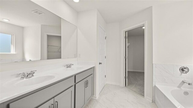 unfurnished bedroom featuring light carpet, a closet, and a spacious closet