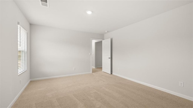 carpeted empty room featuring a healthy amount of sunlight