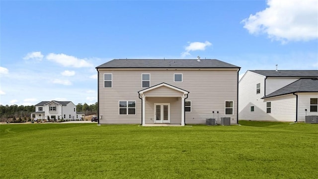 back of house with a lawn, french doors, and central AC unit