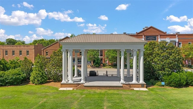 back of house with a gazebo and a lawn