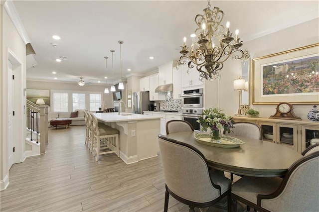 dining space with crown molding, stairway, recessed lighting, and light wood-style floors