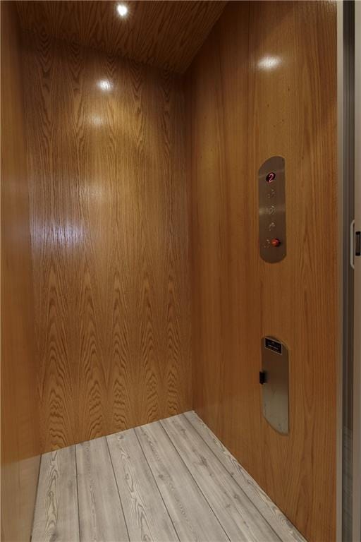 interior details with wooden walls and elevator