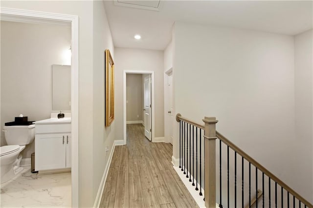 hall featuring marble finish floor, recessed lighting, an upstairs landing, and baseboards