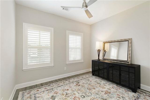 bedroom with baseboards, visible vents, ceiling fan, and wood finished floors