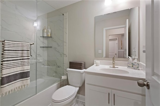 bathroom featuring marble finish floor, combined bath / shower with glass door, vanity, and toilet