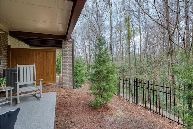 view of patio with cooling unit and fence