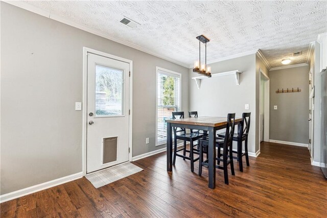 8450 Jot Em Down Rd, Gainesville, GA 30506 - dining room featuring crown molding, dark wood finished floors, visible vents, baseboards, and a chandelier