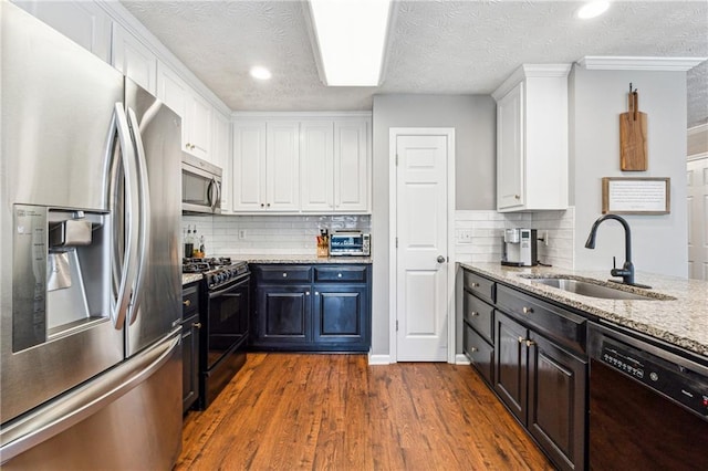 8450 Jot Em Down Rd, Gainesville, GA 30506 - kitchen with a sink, a textured ceiling, white cabinetry, light stone countertops, and black appliances