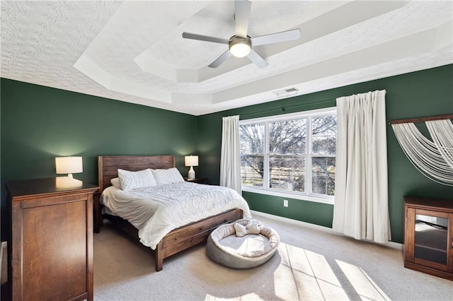 8450 Jot Em Down Rd, Gainesville, GA 30506 - bedroom featuring a textured ceiling, carpet, ceiling fan, a tray ceiling, and baseboards