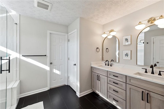 8450 Jot Em Down Rd, Gainesville, GA 30506 - bathroom featuring a stall shower, visible vents, a sink, and double vanity