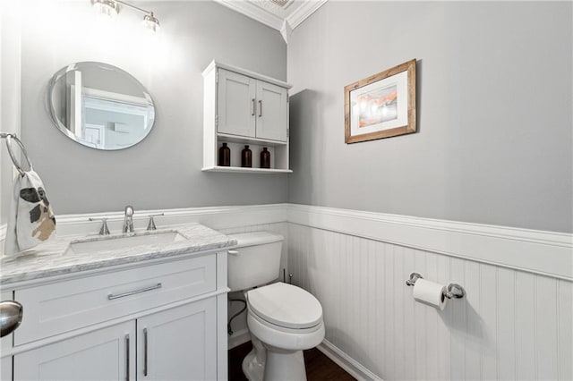 8450 Jot Em Down Rd, Gainesville, GA 30506 - half bathroom featuring wainscoting, vanity, ornamental molding, and toilet