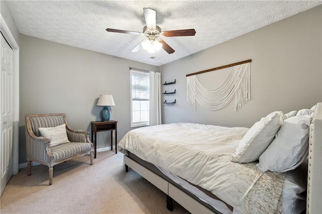 8450 Jot Em Down Rd, Gainesville, GA 30506 - bedroom with a closet, a textured ceiling, visible vents, ceiling fan, and light colored carpet