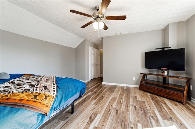 8450 Jot Em Down Rd, Gainesville, GA 30506 - bedroom featuring lofted ceiling, wood finished floors, a textured ceiling, ceiling fan, and baseboards