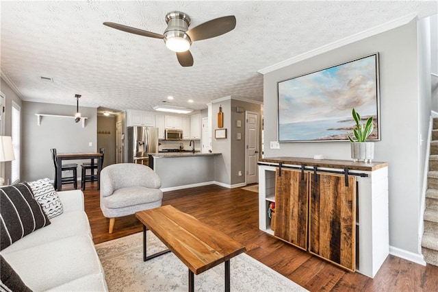 8450 Jot Em Down Rd, Gainesville, GA 30506 - living room with crown molding, stairs, a ceiling fan, and wood finished floors