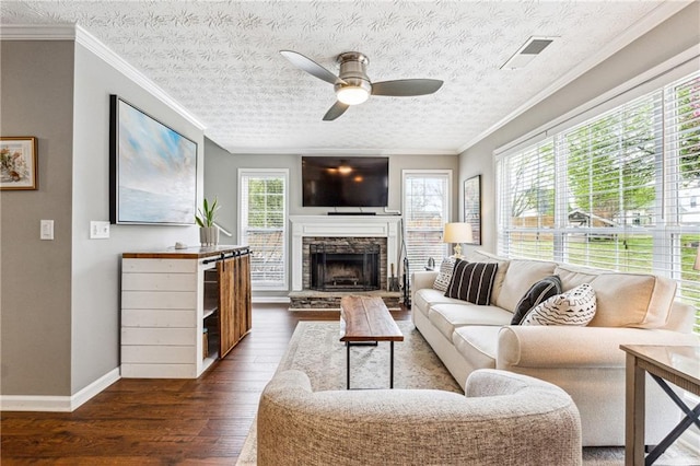 8450 Jot Em Down Rd, Gainesville, GA 30506 - living area with a fireplace, dark wood finished floors, visible vents, baseboards, and ceiling fan