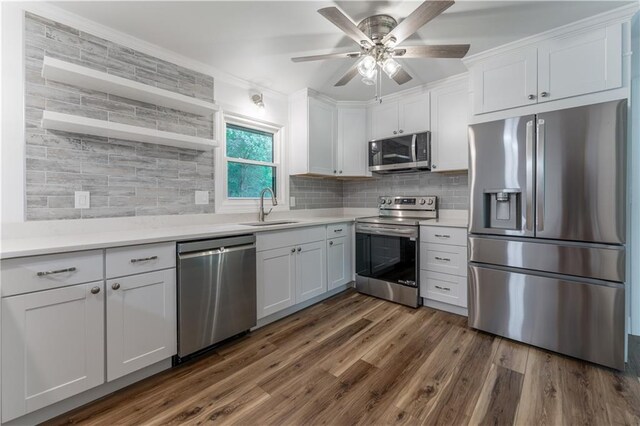 3620 W Lawrenceville St, Duluth, GA 30096 - kitchen featuring stainless steel appliances, white cabinetry, ceiling fan, tasteful backsplash, and ornamental molding