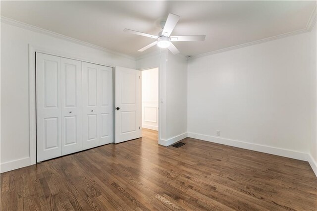 3620 W Lawrenceville St, Duluth, GA 30096 - unfurnished bedroom with crown molding, dark wood-style flooring, a closet, and a ceiling fan