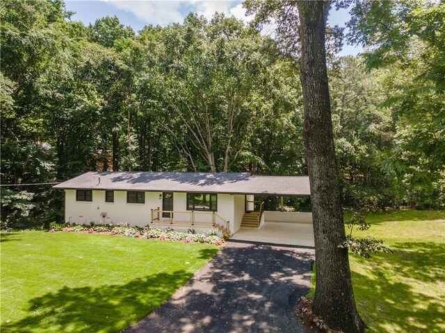 3620 W Lawrenceville St, Duluth, GA 30096 - view of front of home with driveway, a front lawn, and an attached carport