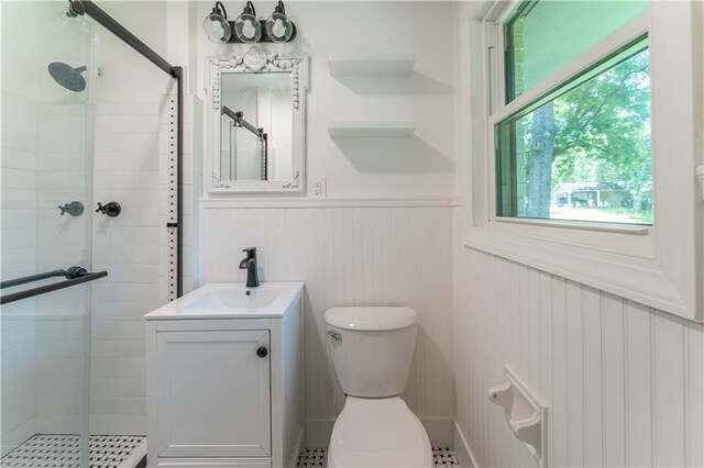 3620 W Lawrenceville St, Duluth, GA 30096 - bathroom featuring a stall shower, a wainscoted wall, and vanity