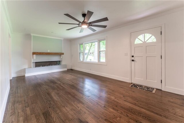 3620 W Lawrenceville St, Duluth, GA 30096 - entryway featuring dark wood-style floors, ceiling fan, ornamental molding, and a fireplace