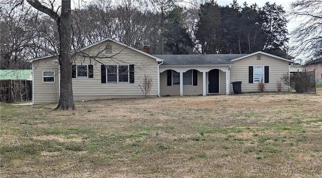 single story home featuring a chimney, a front lawn, and fence