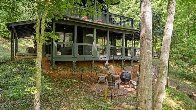 rear view of house with a fire pit