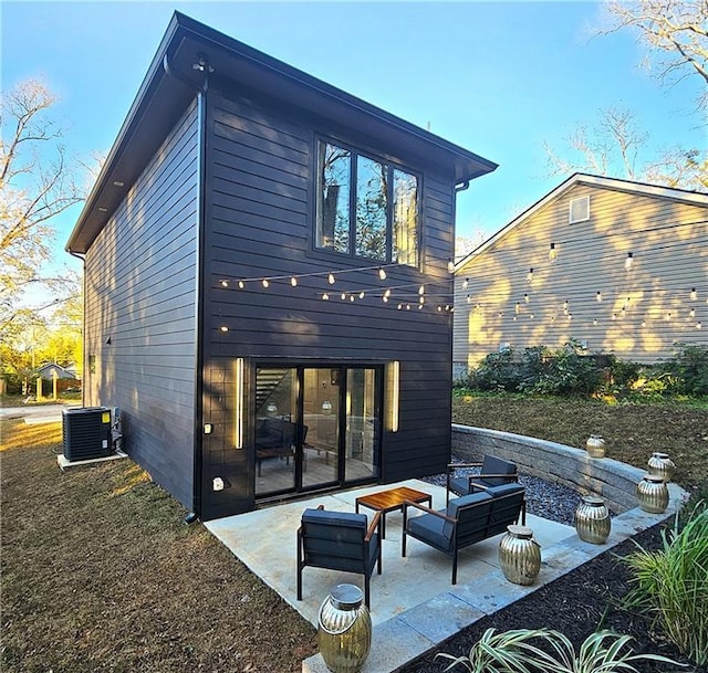 rear view of property with outdoor lounge area, central AC, and a patio area