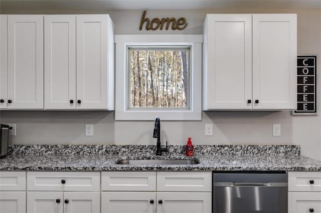 kitchen with light stone countertops, dishwasher, sink, and white cabinetry