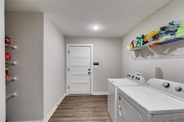 clothes washing area featuring dark hardwood / wood-style flooring and washing machine and clothes dryer