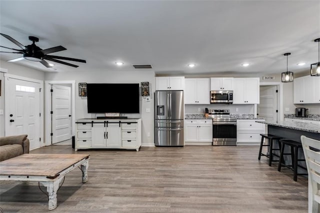 living room featuring light wood-type flooring and ceiling fan