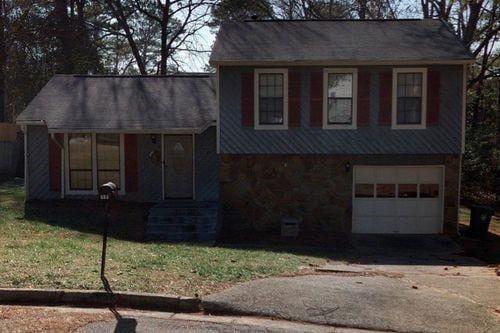 split level home featuring a garage and a front yard