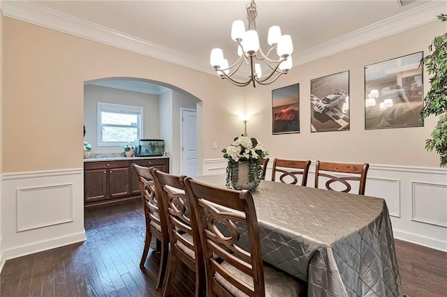 4708 Tiger Blvd, Duluth, GA 30096 - dining space featuring arched walkways, a decorative wall, a chandelier, wainscoting, and crown molding