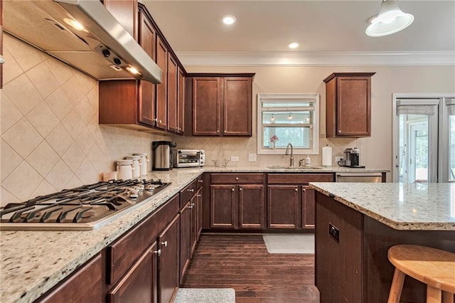 4708 Tiger Blvd, Duluth, GA 30096 - kitchen with stainless steel gas cooktop, wall chimney range hood, a sink, ornamental molding, and light stone countertops