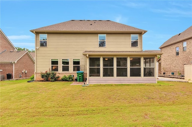 4708 Tiger Blvd, Duluth, GA 30096 - rear view of house featuring a sunroom, a yard, central AC unit, and brick siding