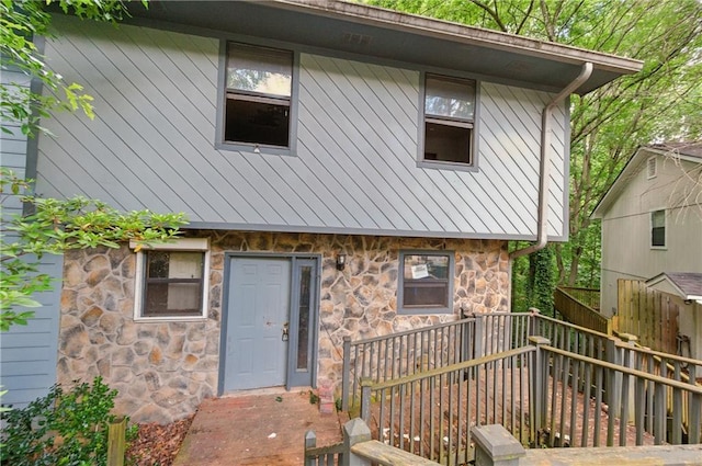 1352 Overlook Cv SE, Smyrna, GA 30080 - back of house featuring stone siding, a standing seam roof, a metal roof, and a deck