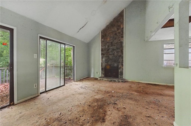 1352 Overlook Cv SE, Smyrna, GA 30080 - unfurnished living room with plenty of natural light, a fireplace, and vaulted ceiling