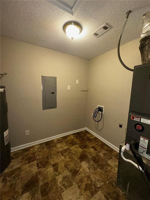 washroom with washer hookup, electric panel, water heater, and a textured ceiling