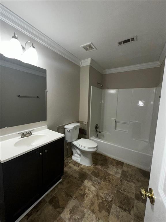 full bathroom with crown molding, shower / bathtub combination, vanity, and toilet