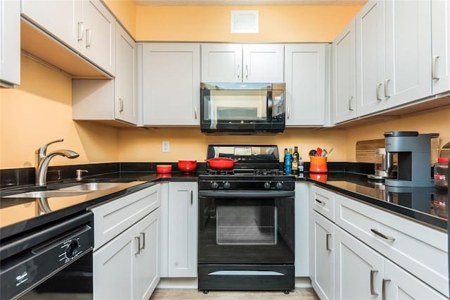 kitchen with white cabinetry, sink, and black appliances