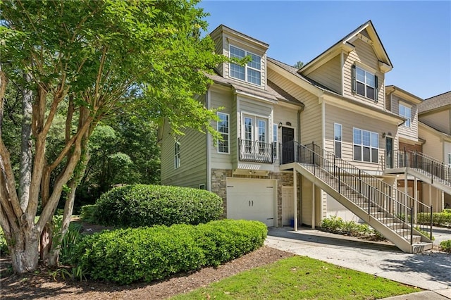 3150 Stonewyck Pl, Decatur, GA 30033 - view of front facade with a garage, stairs, driveway, and stone siding