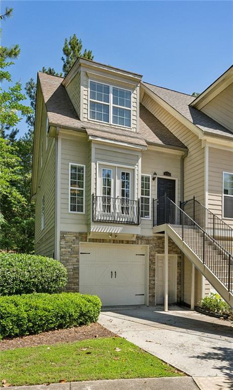 3150 Stonewyck Pl, Decatur, GA 30033 - view of front of property with a garage, stone siding, stairs, concrete driveway, and a shingled roof