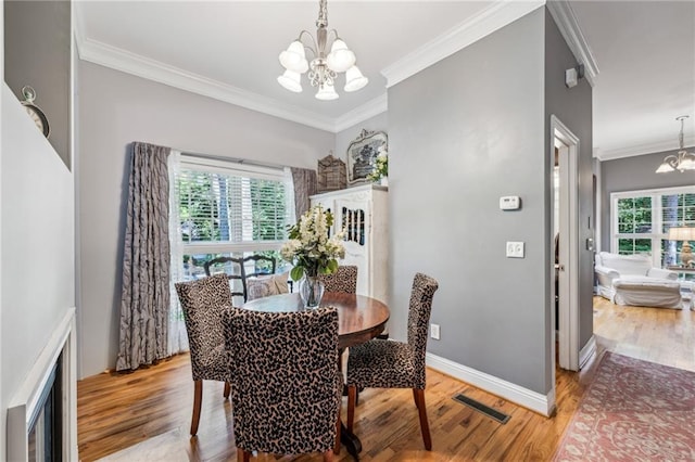 3150 Stonewyck Pl, Decatur, GA 30033 - dining space with a chandelier, ornamental molding, light wood finished floors, and baseboards