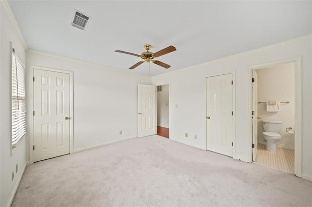 unfurnished bedroom featuring crown molding, ensuite bath, ceiling fan, and light carpet