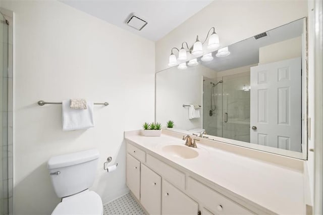 bathroom with vanity, toilet, and a shower with shower door