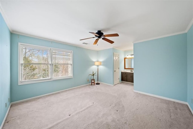 carpeted empty room featuring crown molding and ceiling fan