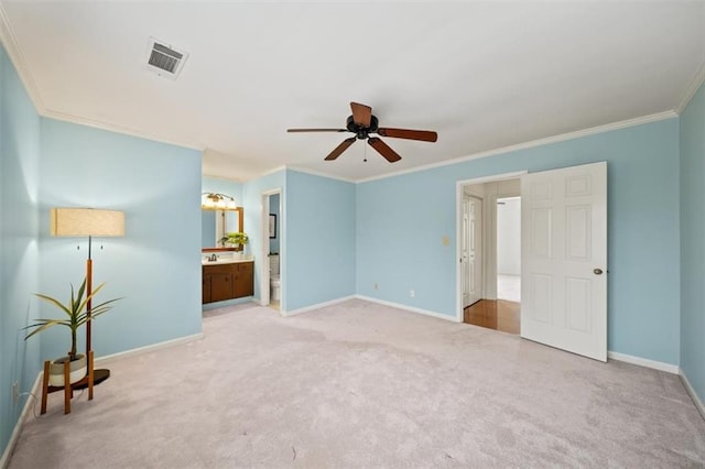 unfurnished bedroom featuring crown molding, carpet, ceiling fan, and ensuite bath