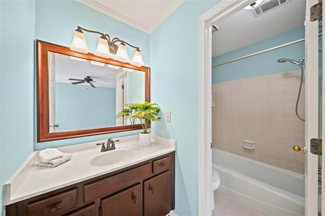 full bathroom featuring crown molding, vanity, tile patterned floors, toilet, and tiled shower / bath